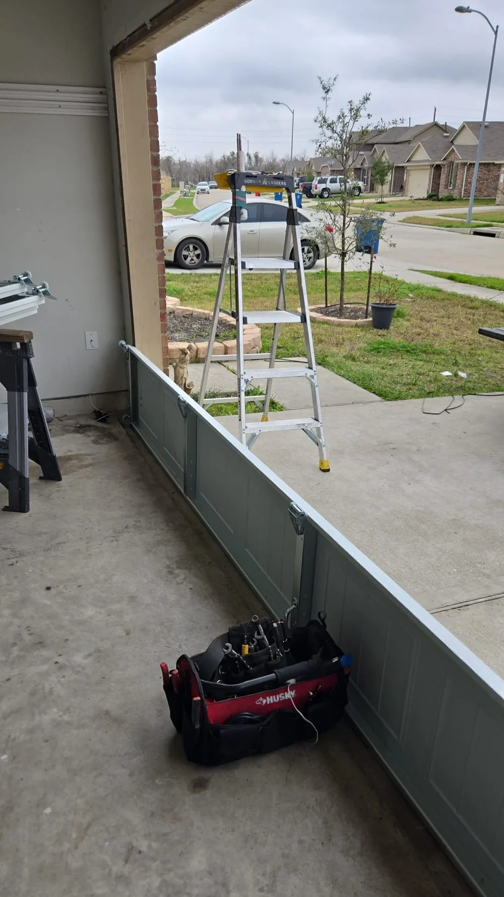 Vertical view of garage opening with partially installed door and equipment