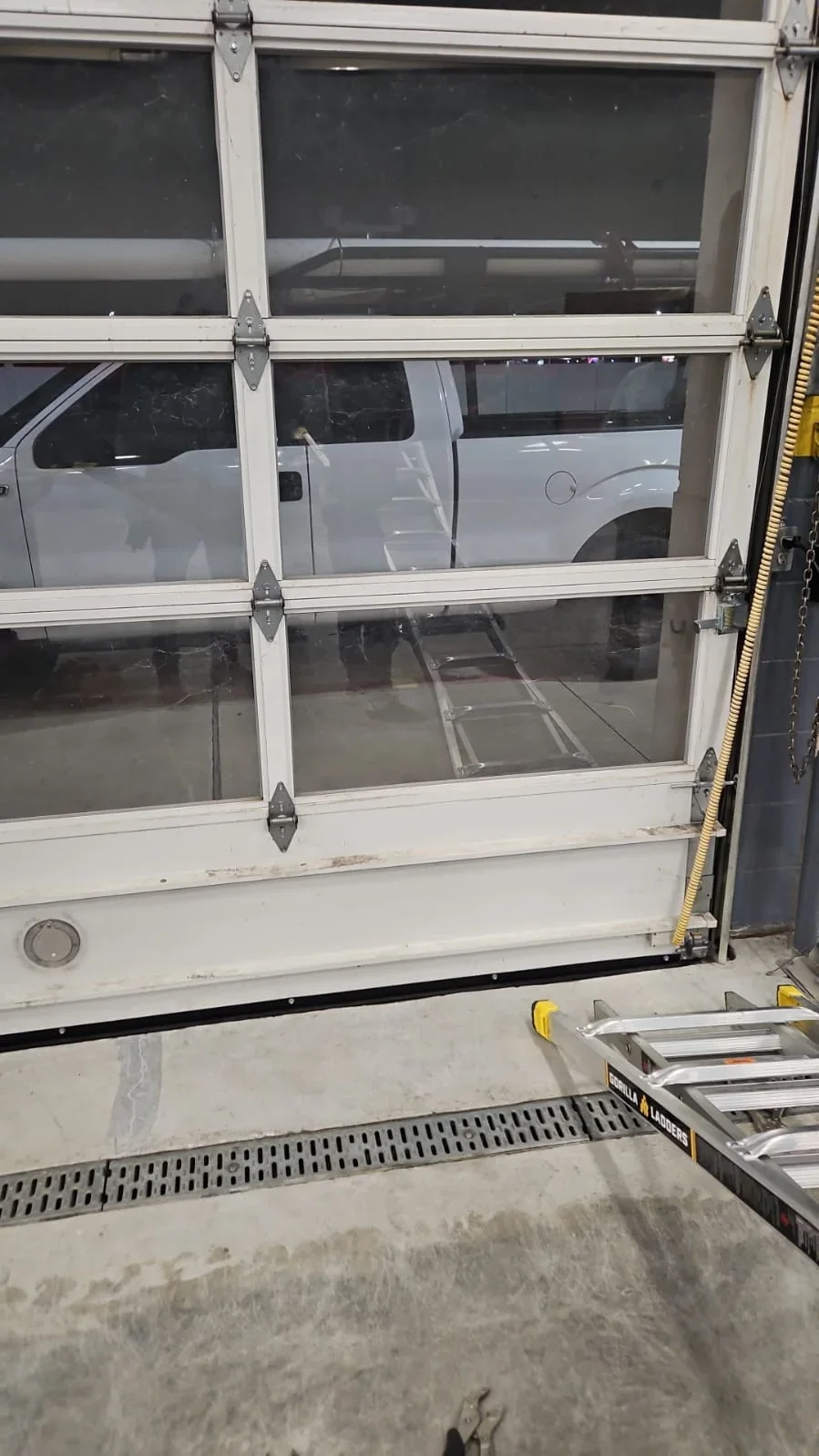 Close vertical view of sectional garage door interior and panel hardware