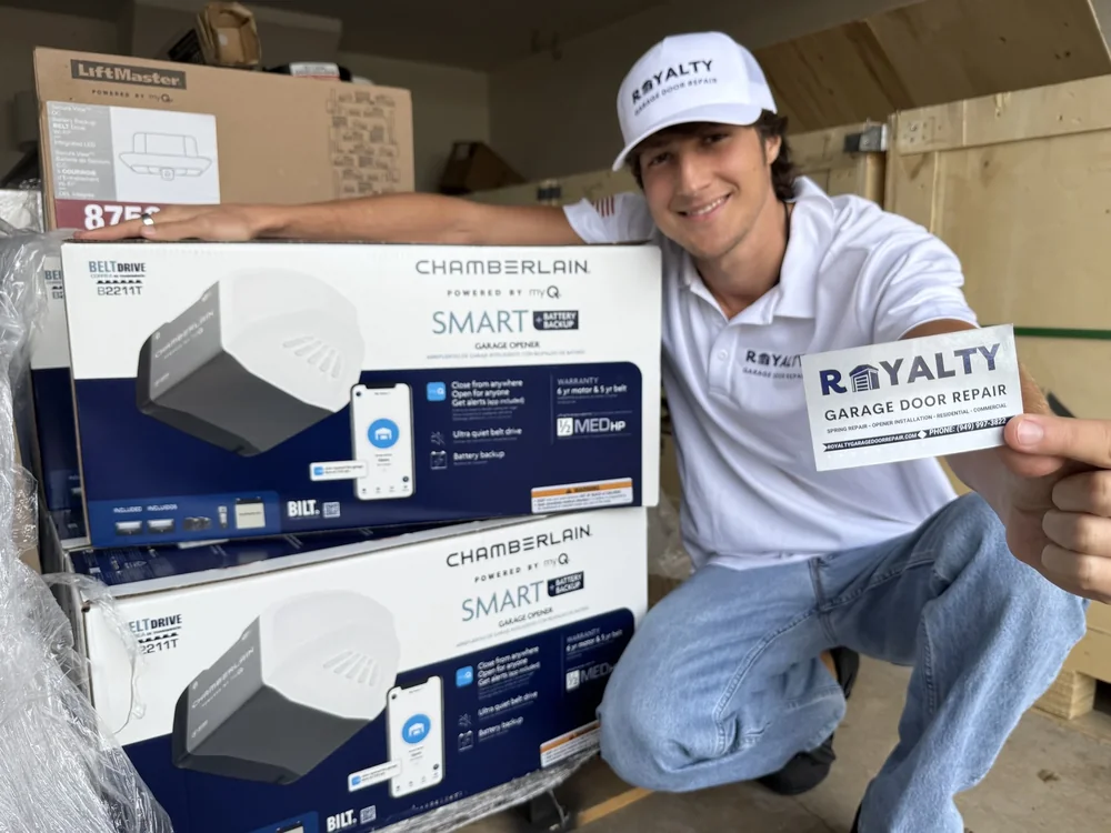 Smiling Royalty technician with Chamberlain smart opener boxes