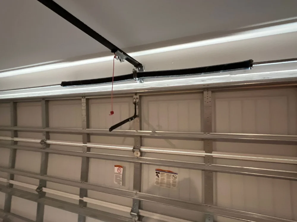 Closed garage door and overhead torsion spring system